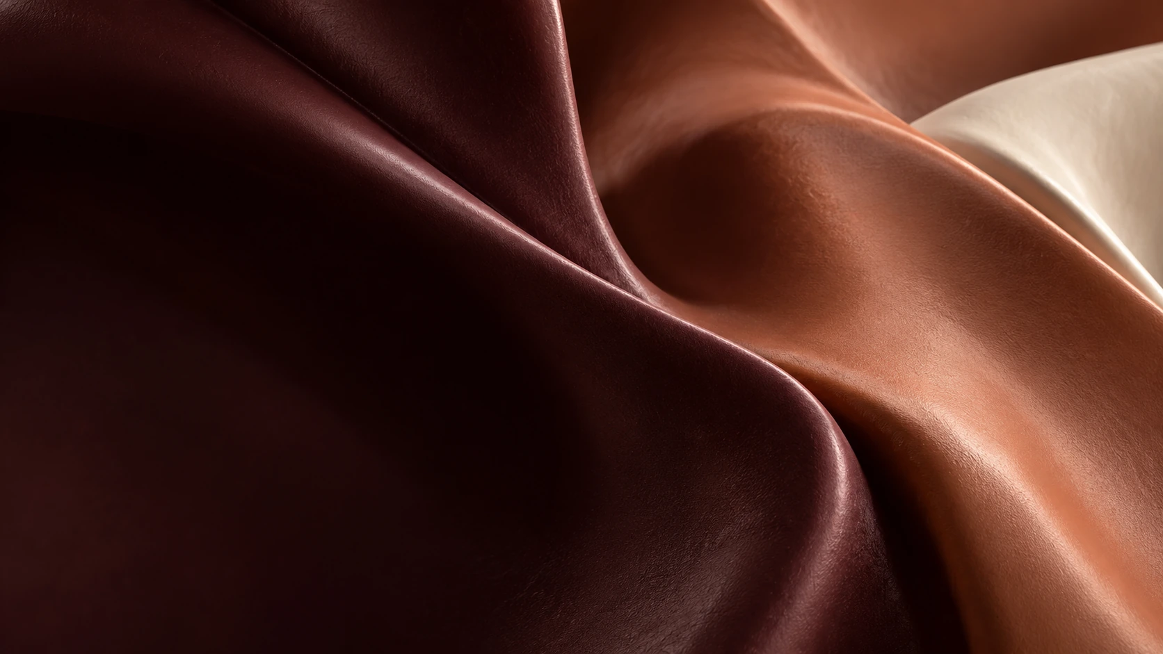 Sculptural folds in wine, clay and ivory, seen in close-up